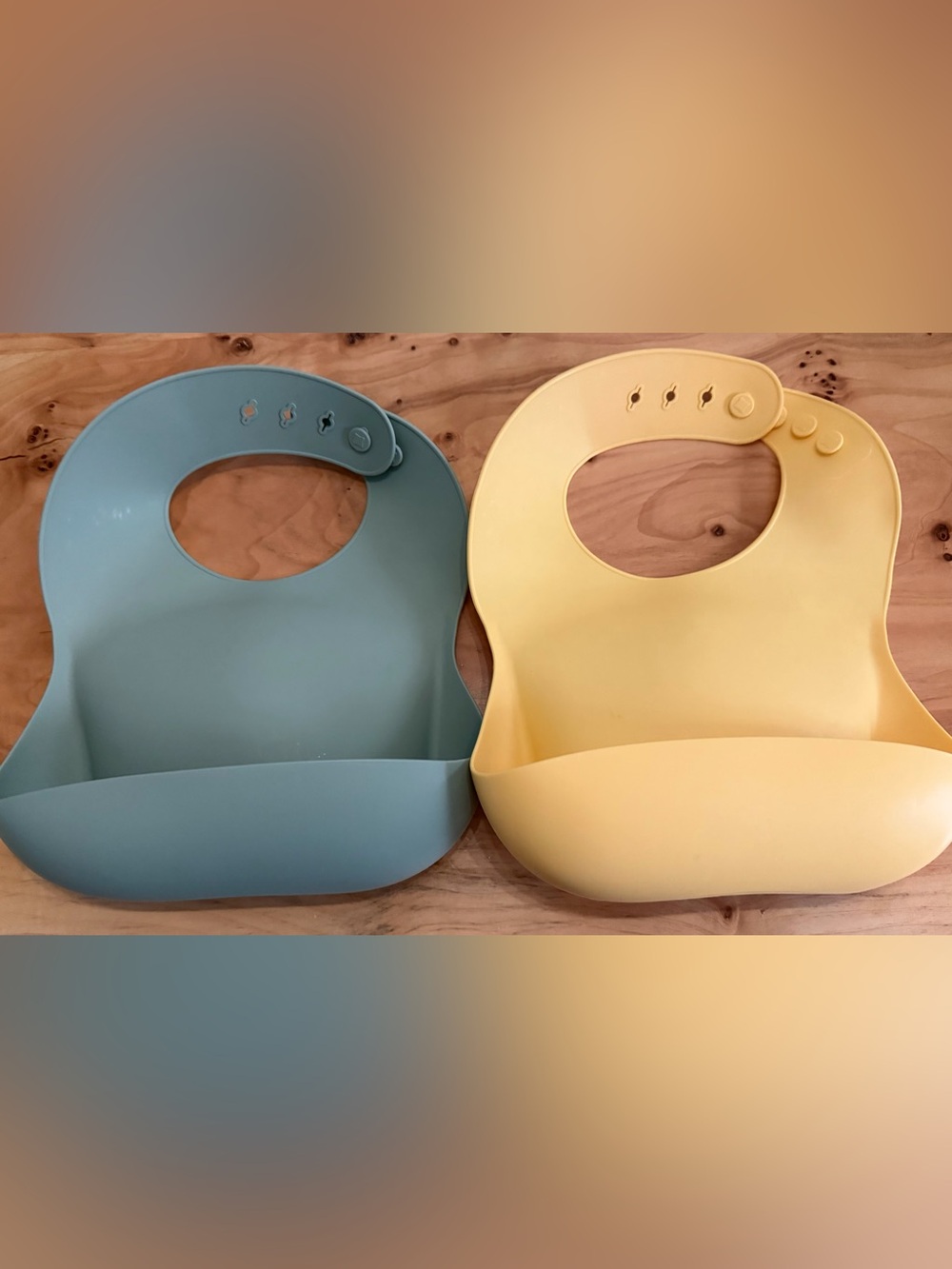 Mushie Adjustable Silicone Bibs for Toddlers in Sage Green and Pale Yellow